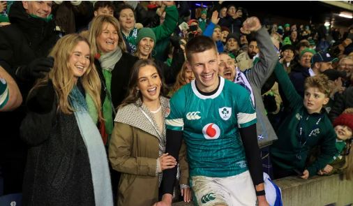 Roinn an lánúin nóiméad bródúil le chéile ar an dtaobhlíneleis an lucht leanúna